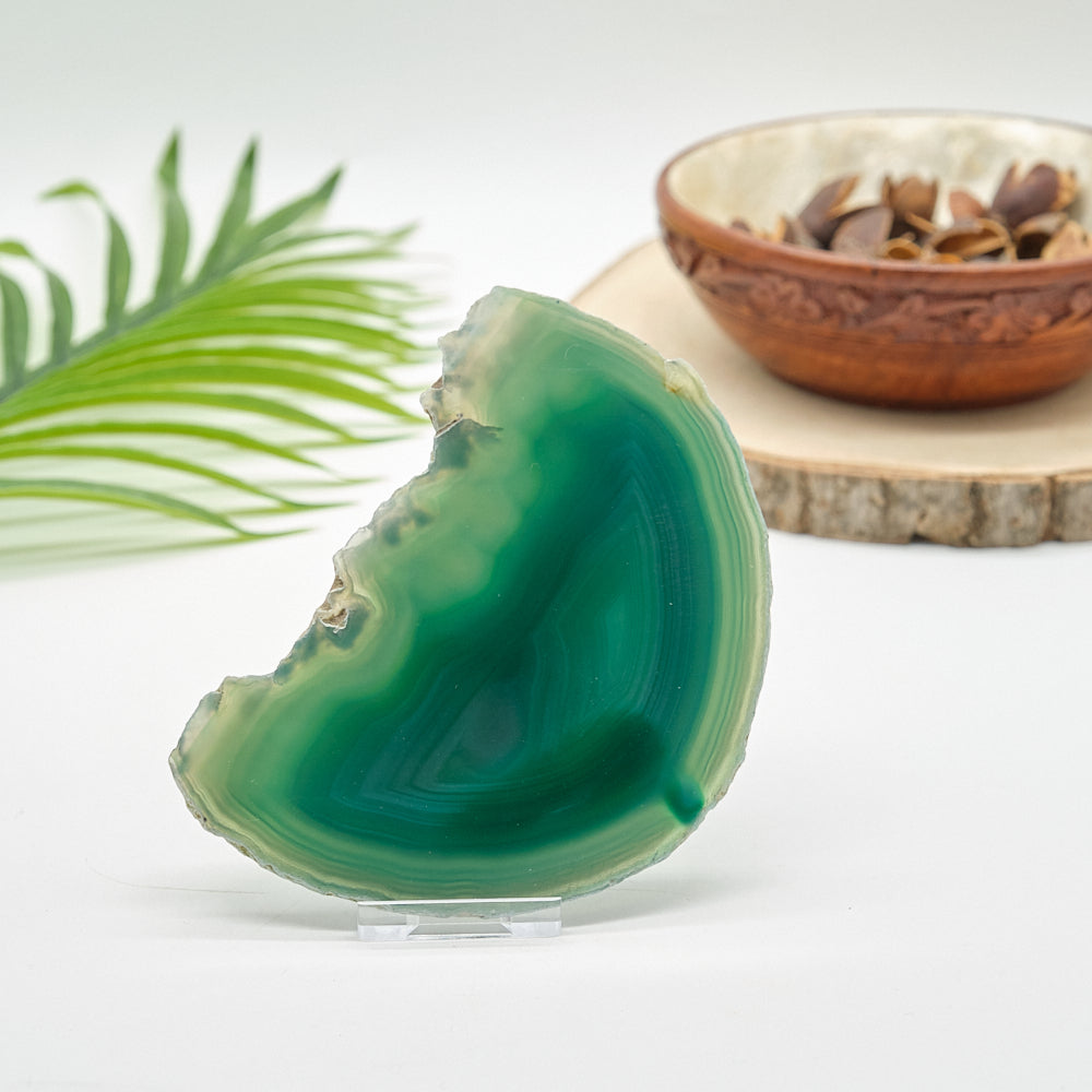 Green agate stone on a stand with a blurred background