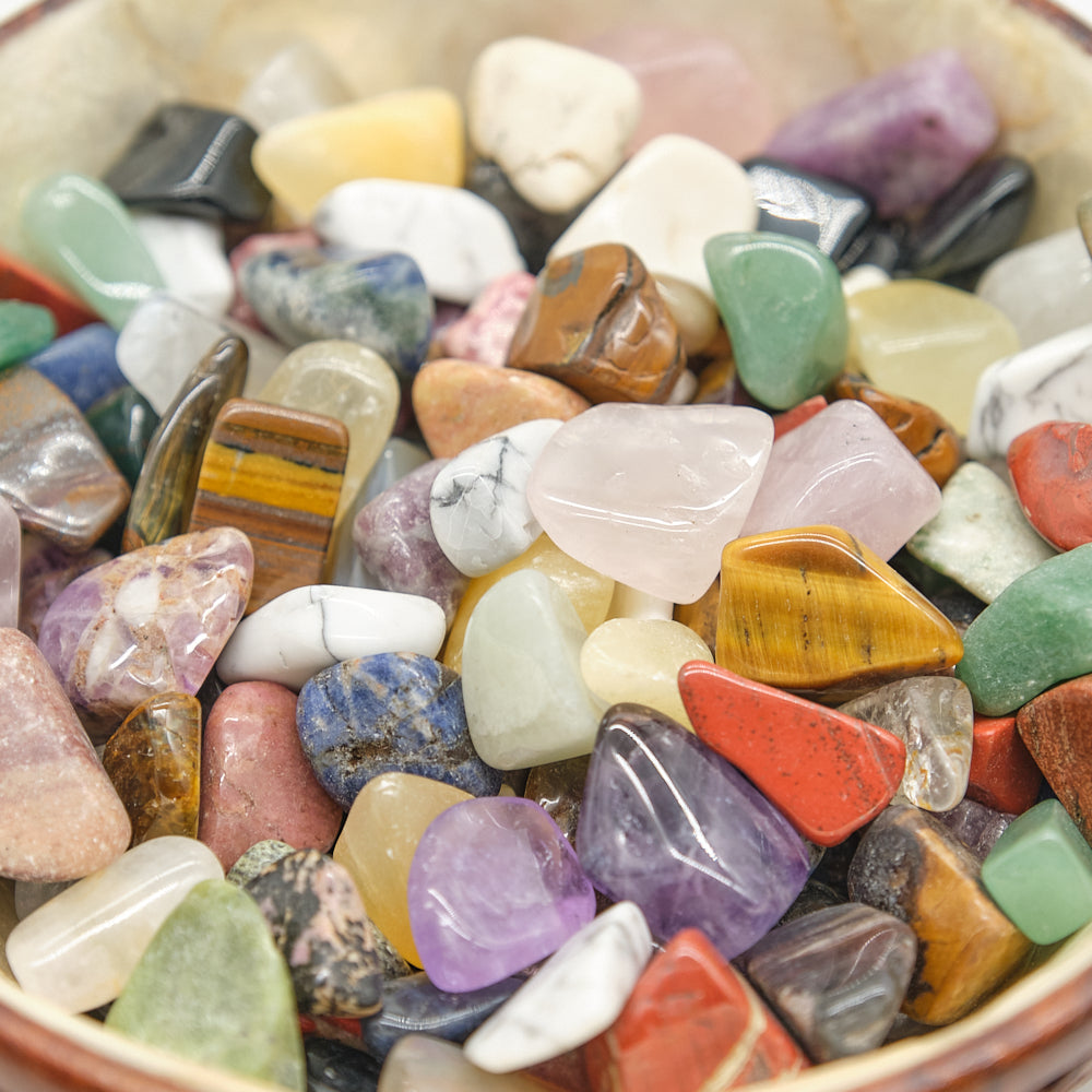 Assorted colorful gemstones in a bowl