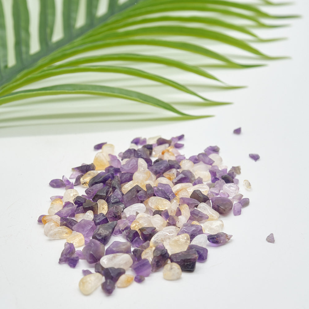 amethyst citrine Small stones on a light background with a green leaf