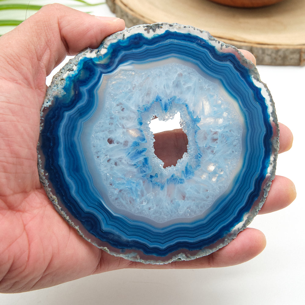 Hand holding a blue agate slice