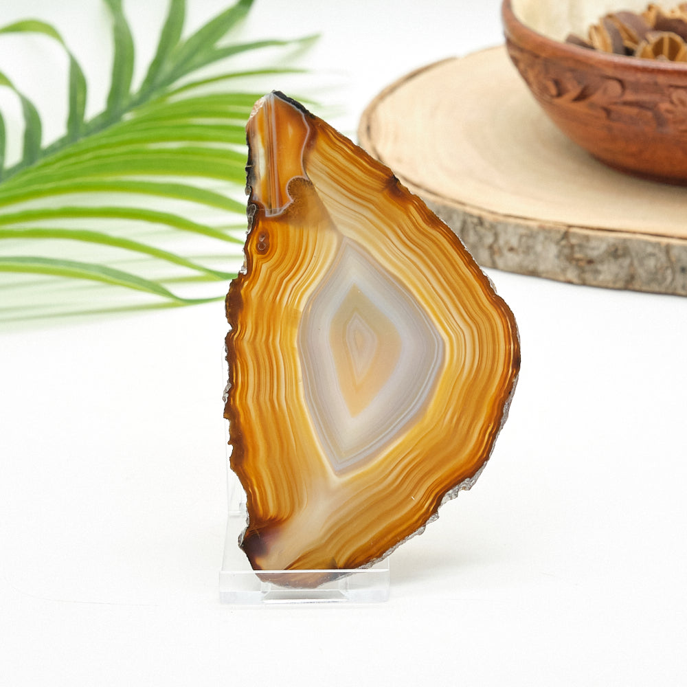 Sliced agate stone with a wooden bowl in the background