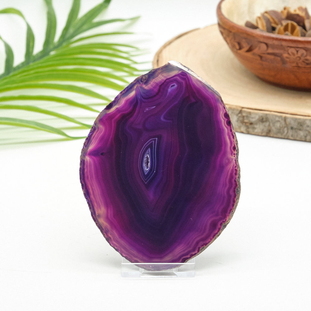 Purple agate stone on a stand with a blurred background