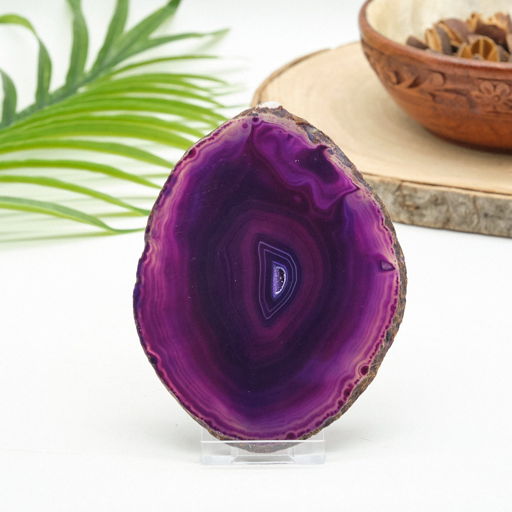 Purple agate stone on a stand with a blurred background
