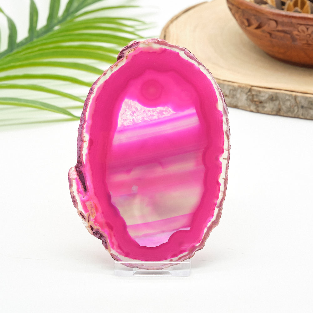 Pink and white geode crystal on a white background with a natural setting