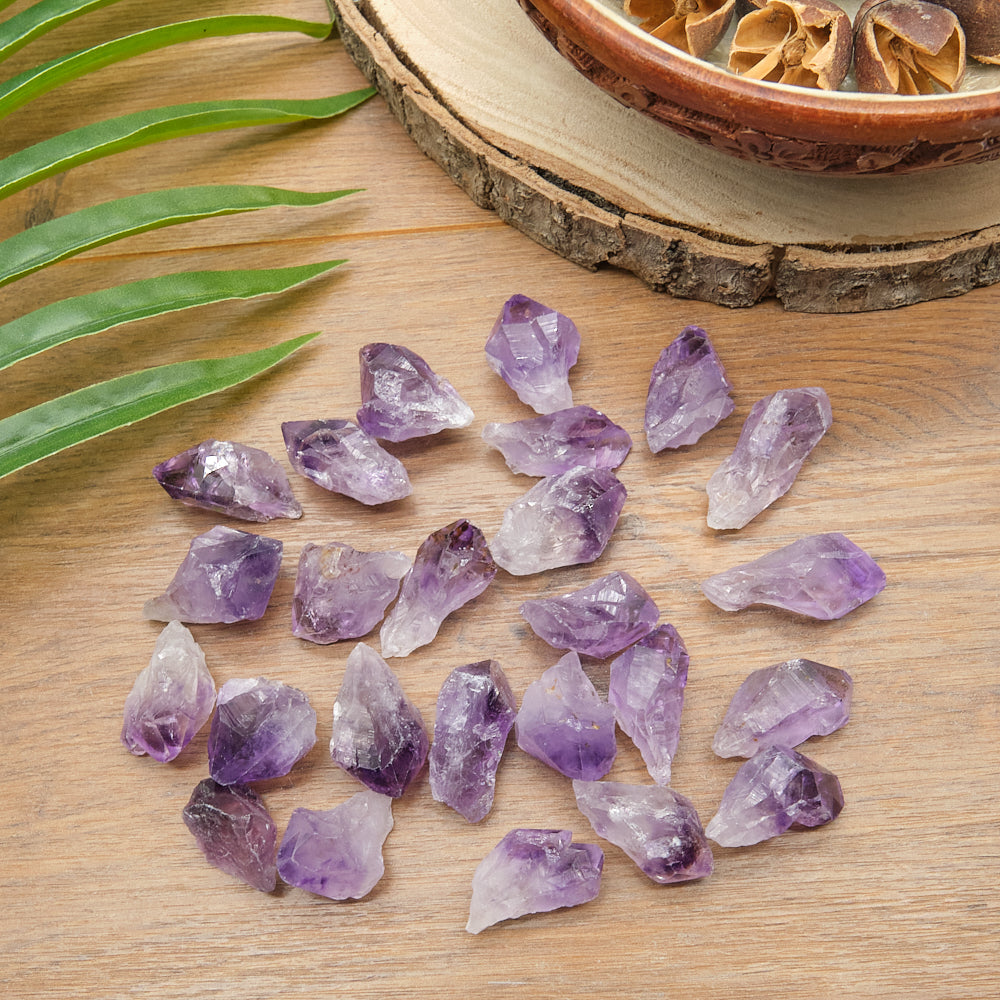 Amethyst crystals on a wooden surface with a natural background