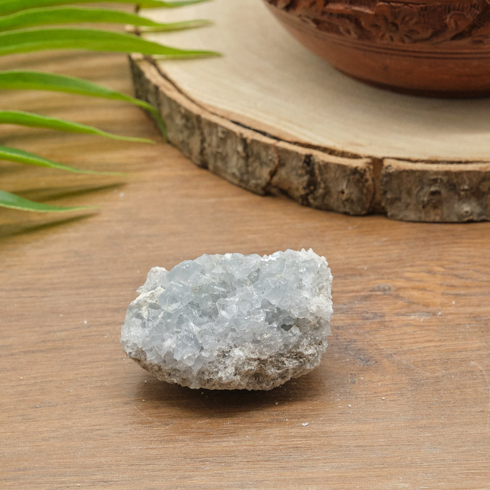 celstite Crystal rock on a wooden surface with a natural background