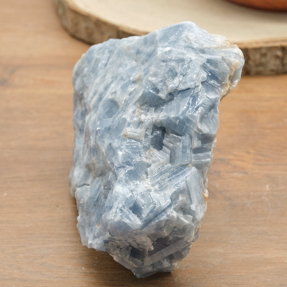 Blue calcite crystal rock on a wooden surface
