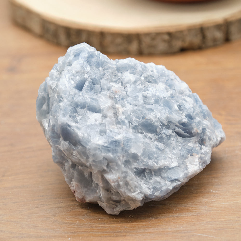 Raw blue calcite stone on a wooden surface