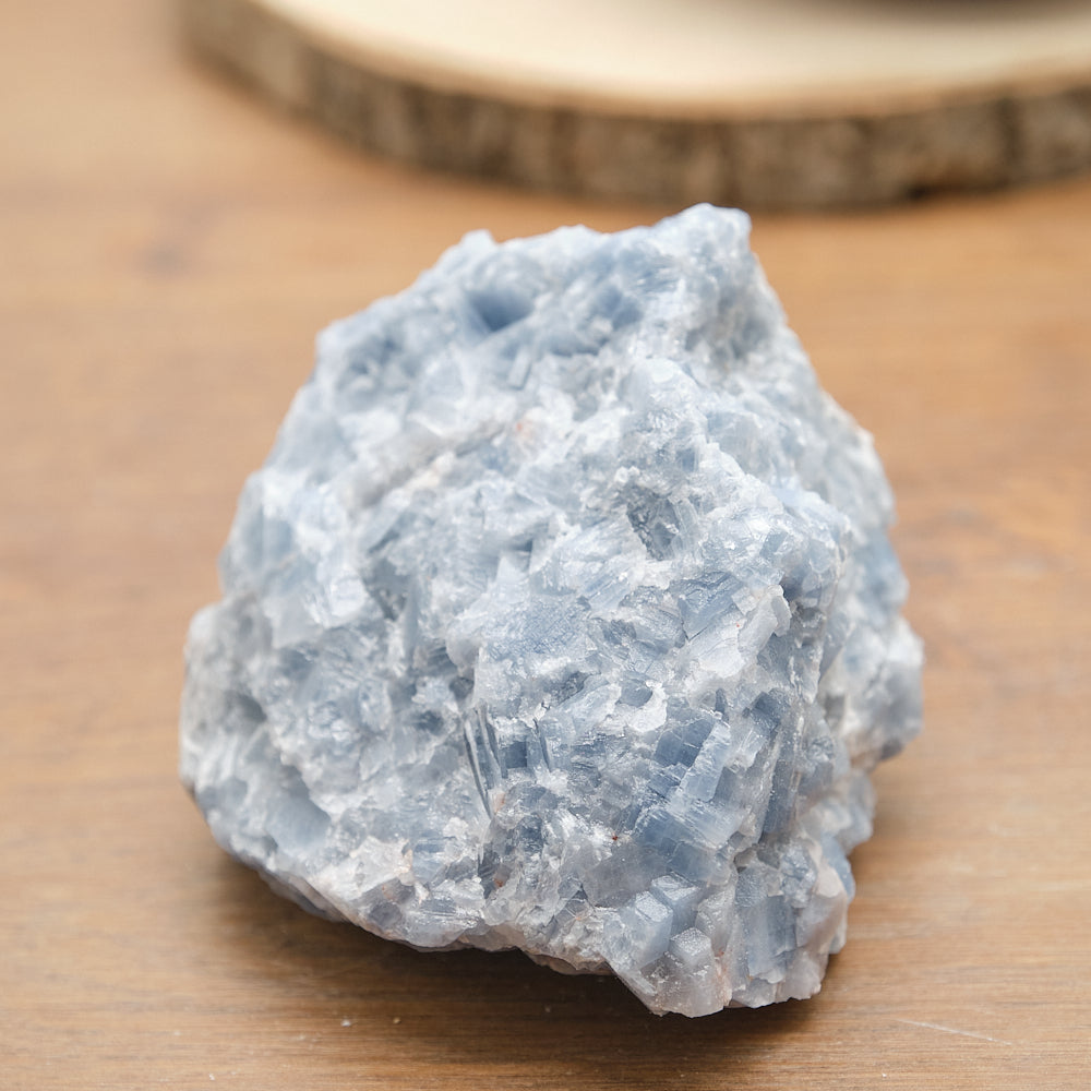 Raw blue calcite stone on a wooden surface