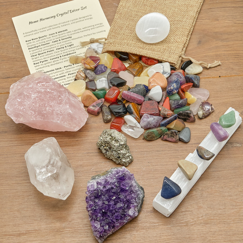 Collection of crystals on a wooden surface with a bag of crystals and a card.