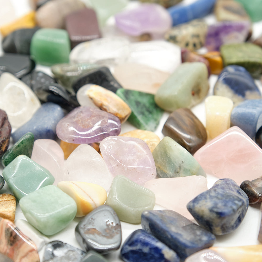 Assorted colorful stones and crystals on a white background