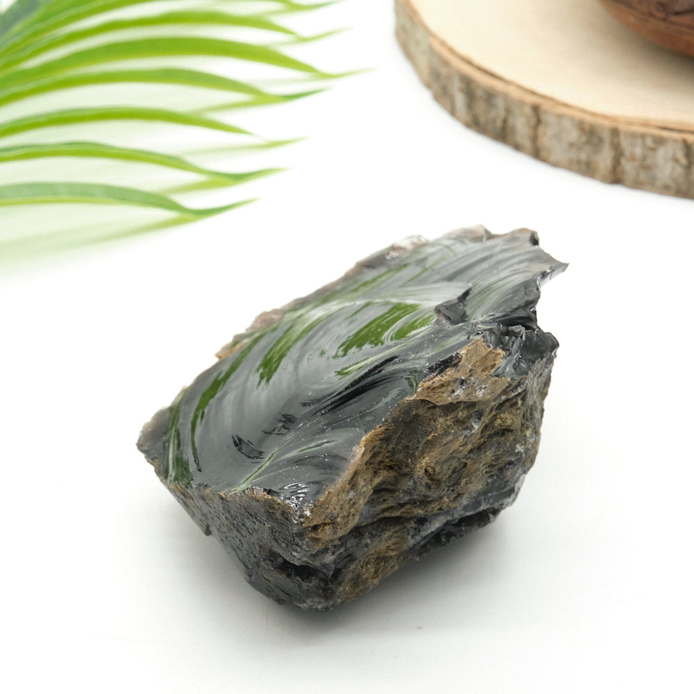 large black obsidian rock on white surface