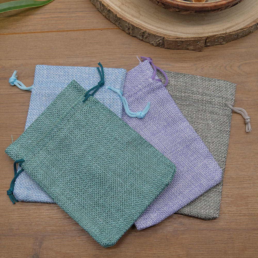 Set of colorful drawstring bags on a wooden surface