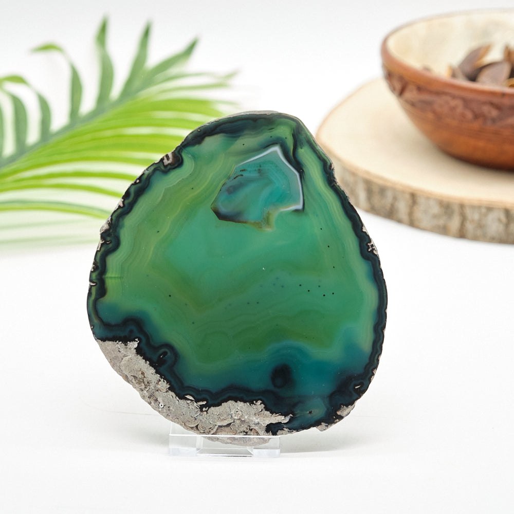 Green agate stone on a white surface with a blurred background