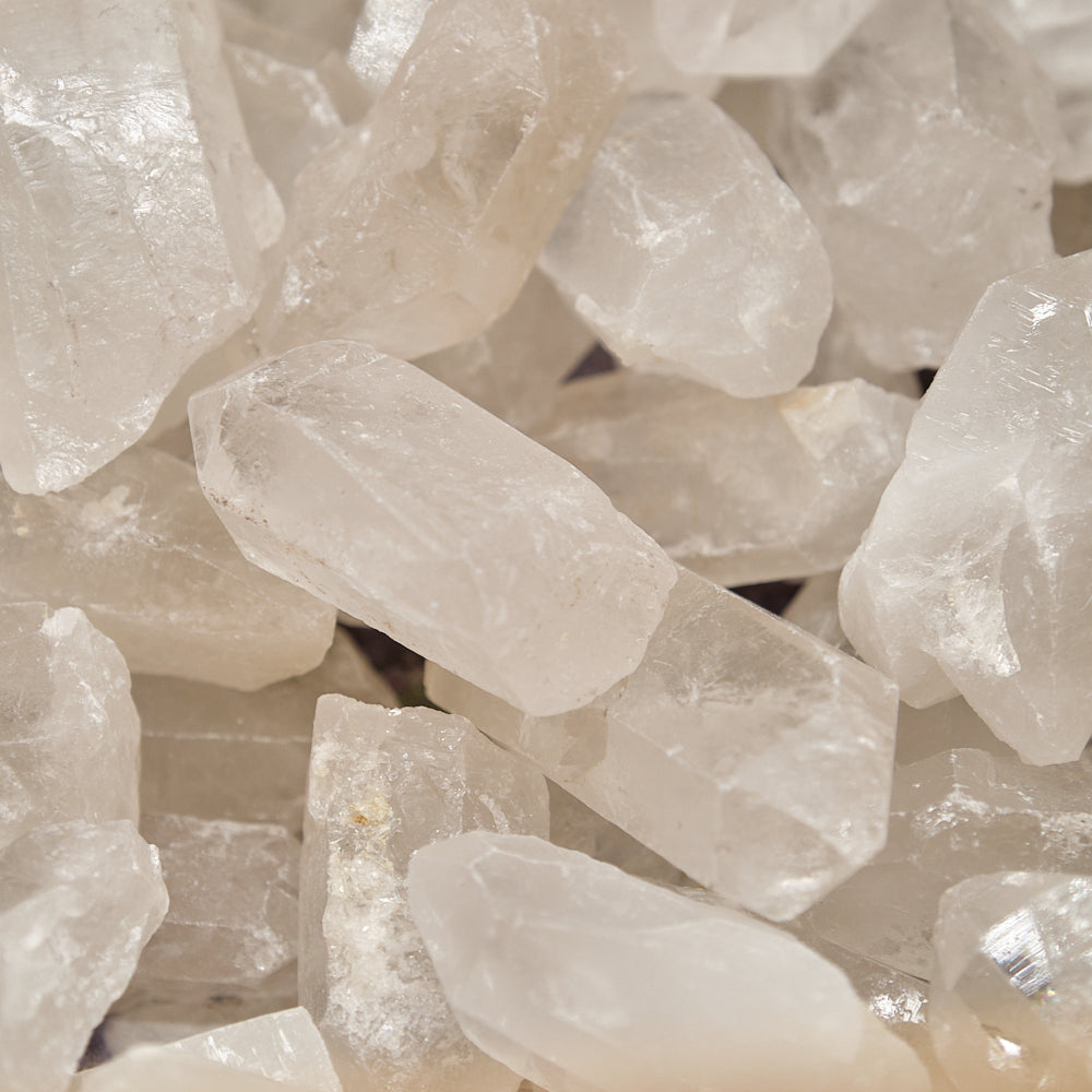 Close-up of clear quartz crystal points rocks on a beige background