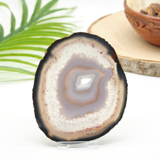 Sliced agate stone with concentric patterns on a white background
