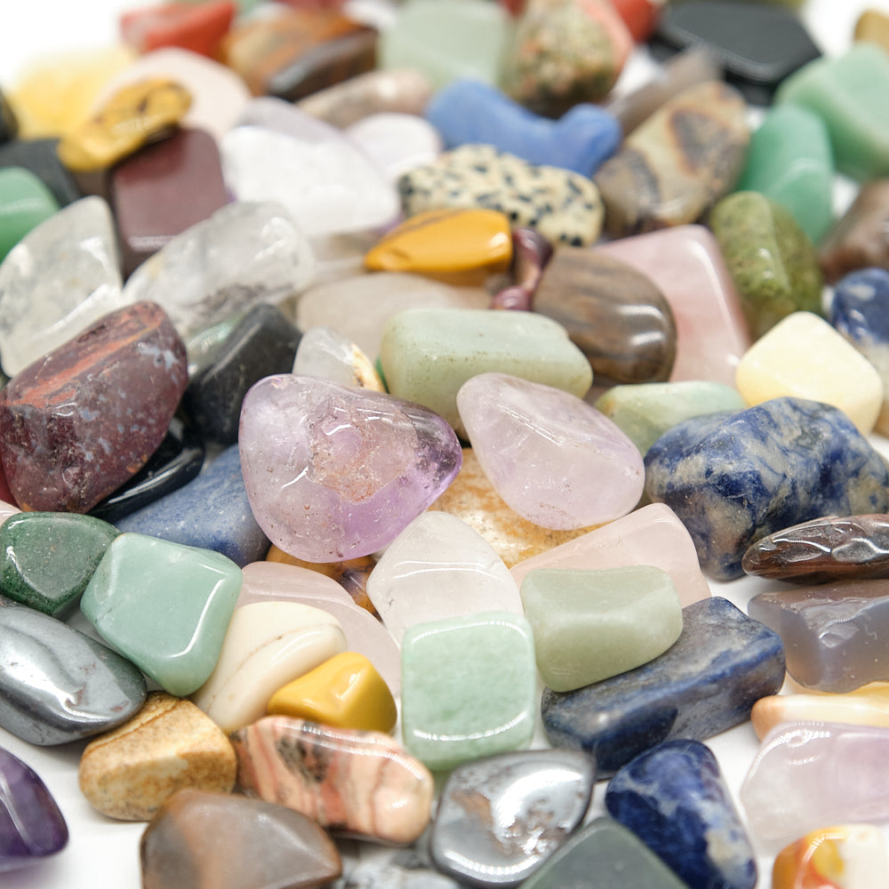 Assorted multicolored gemstones on a white background