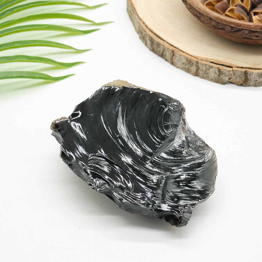 large rough black obsidian crystal rock on white background 