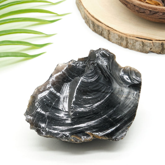 large black obsidian rock on white surface