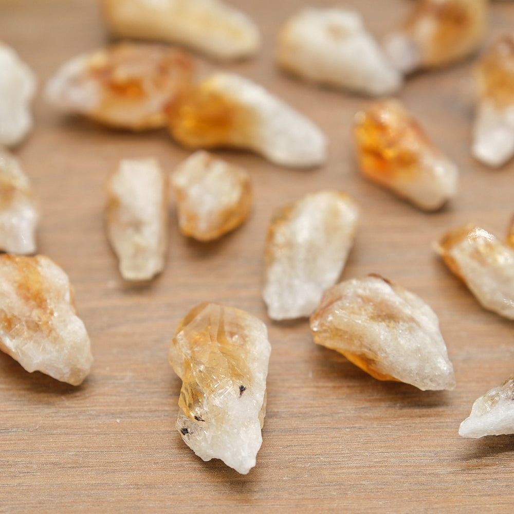Close-up of citrine points crystal rocks on a wooden surface