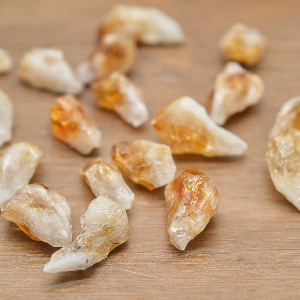 Raw citrine points s on a wooden surface