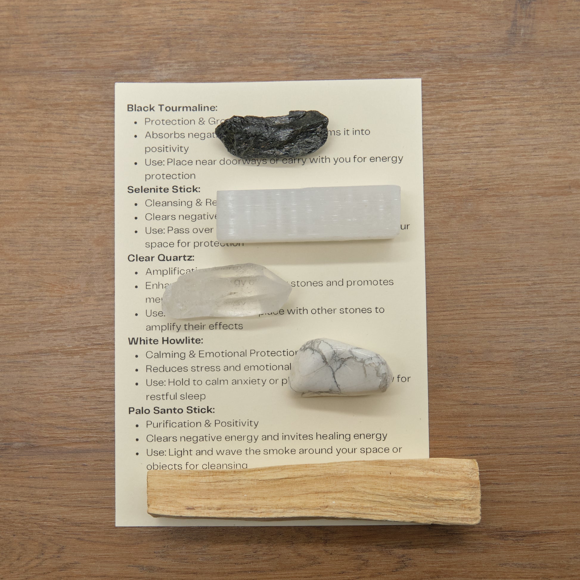 protection crystals set with quartz point, black tourmaline, white howlite, palo santo stick, selenite and meaning card