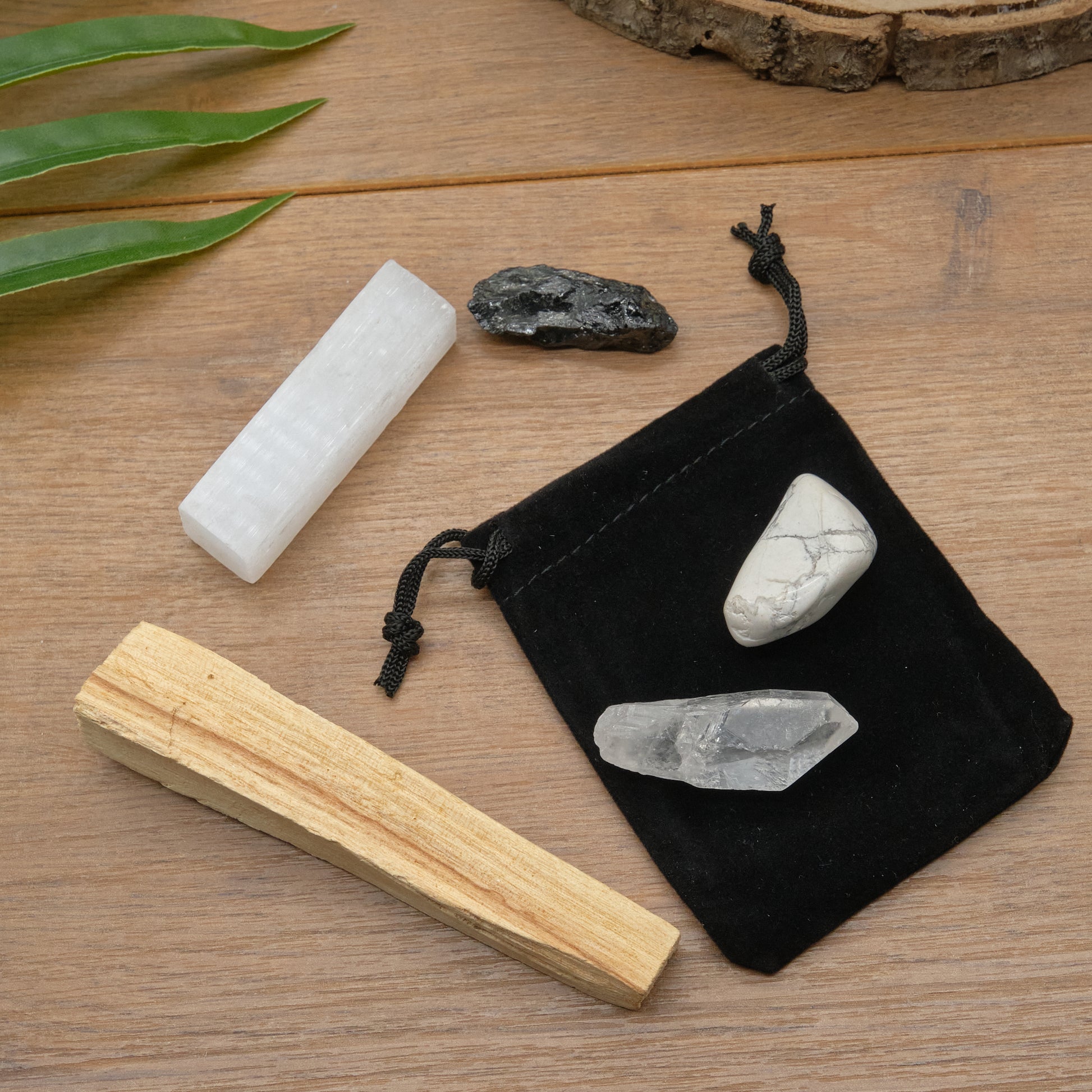 protection crystals set with quartz point, black tourmaline, white howlite, palo santo stick, selenite and meaning card